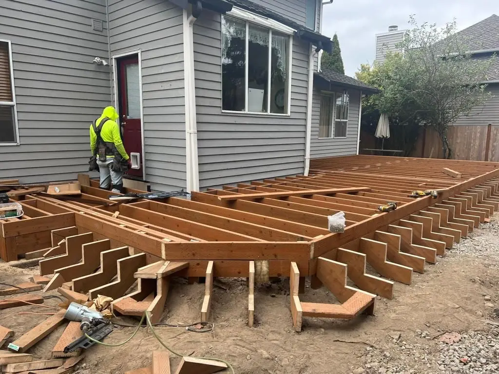 Custom Deck Builder building outdoor entertainment deck with seating and gathering space